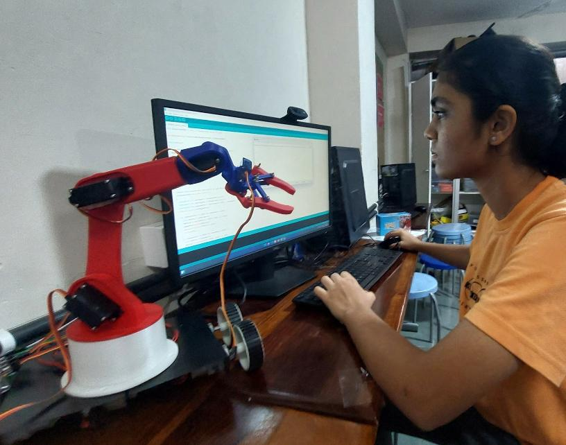 Kashvi working on a robotic arm project