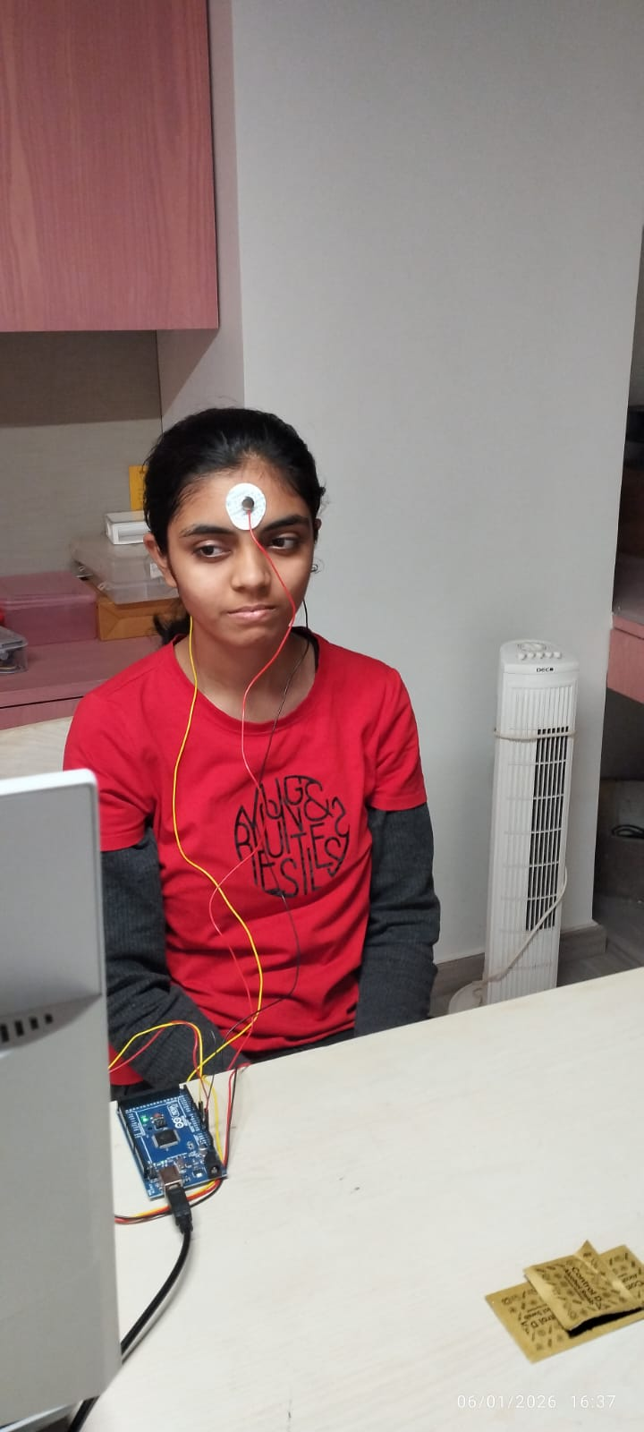 Kashvi wearing a single-channel EEG wearable connected to a microcontroller
